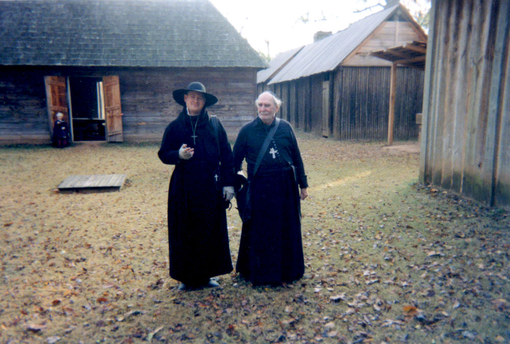 photo of historical interpreters at Fort St. Jean Baptiste dressed as French Jesuit priests