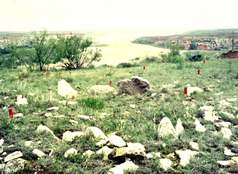 Large limestone slabs on edge strongly suggest buried pit-house walls.