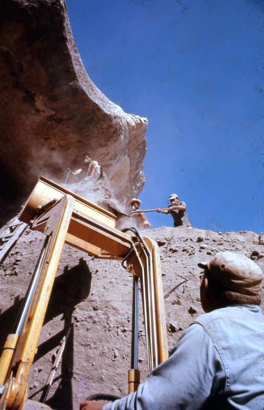 >Harold Beall waits as crew members on top of the excavation block shovel dirt into the backhoe�s bucket