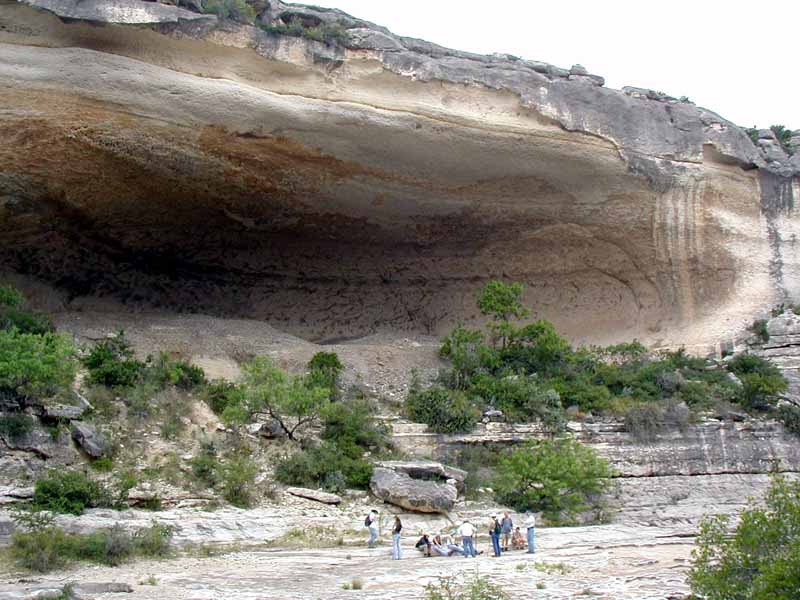 Eagle Cave, a short walk downstream from Bonfire Shelter. The cultural deposits in Eagle Cave are over 35 feet thick. The roof of this "cave" is similar to the original roof of Bonfire, before much of it collapsed. Photo by Steve Black.