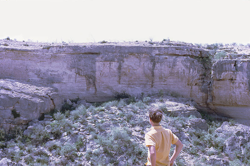 Hugh Davis studies Bonfire Shelter from opposite canyon wall, 1967. Photo by Mott Davis.