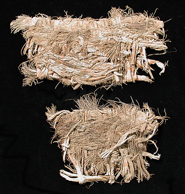 Matched pair of sandals from Fiber Layer. The smaller sandal is missing part of its length due to poor preservation. Total length of the larger one is about 10 inches. Photo by Milton Bell.