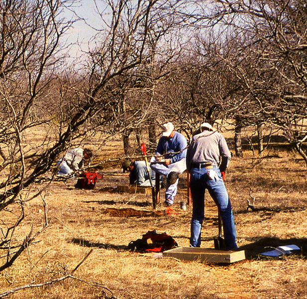 photo of archeologists doing a survey