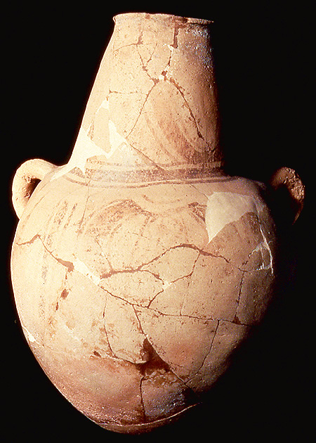 This is a photograph of a water jar traded into the Rio Grande Delta area from the region of Tampico, Mexico. Note the offset looped handles to aid in strapping the vessel to one's back with rope or cordage. The jar was found in pieces and has been glued back together. Much of the painted design has faded due to exposure to the winds and sand before the vessel pieces were discovered.