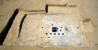 Room 13, a shallow pithouse, was one of the isolated structures found at the site. Structures of this kind were first recognized at Firecracker Pueblo as the result of short-term or seasonal occupation by puebloan people. Room 13 has many of the same characteristics of pueblo rooms: a plastered hearth, caliche-plastered floor, and post holes. It is on the small side…rooms like this range from about 6 to 11 square meters in size. Room 13 burned and the presence of burned shelled and cob corn, beans, and gourds tells us that at the time it was being used for storage.