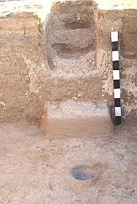 Stepped entry or stairway through the south wall into Room 25, a deep pithouse. Just inside the room is a typical plastered floor hearth, placed near the door for ventilation. The adobe "step" on the south wall has been noted previously for pueblo rooms, but the combination of step and stairway is unique for the region.