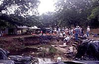 Visitors gather around the Lindsey Pit, one of the main excavation areas where Clovis deposits have been exposed. This area is difficult to work in because of the high water table.