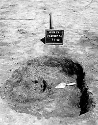 Trash pit (Feature 5a) after excavation, showing irregular bottom of pit. Photo by E. Mott Davis, July 1962.