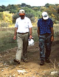 TARL archeologists survey along a road in the project area. Left, Dr. Tom Hester, right, Paul Maslyck.