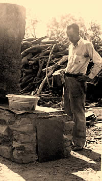 A WPA worker keeps a watchful eye on a pan heating