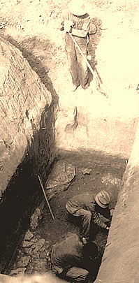 workers at the bottom of a deep excavation unit