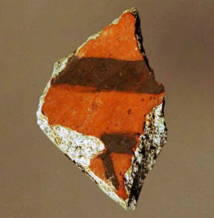 photo of pottery sherd with black line on red body
