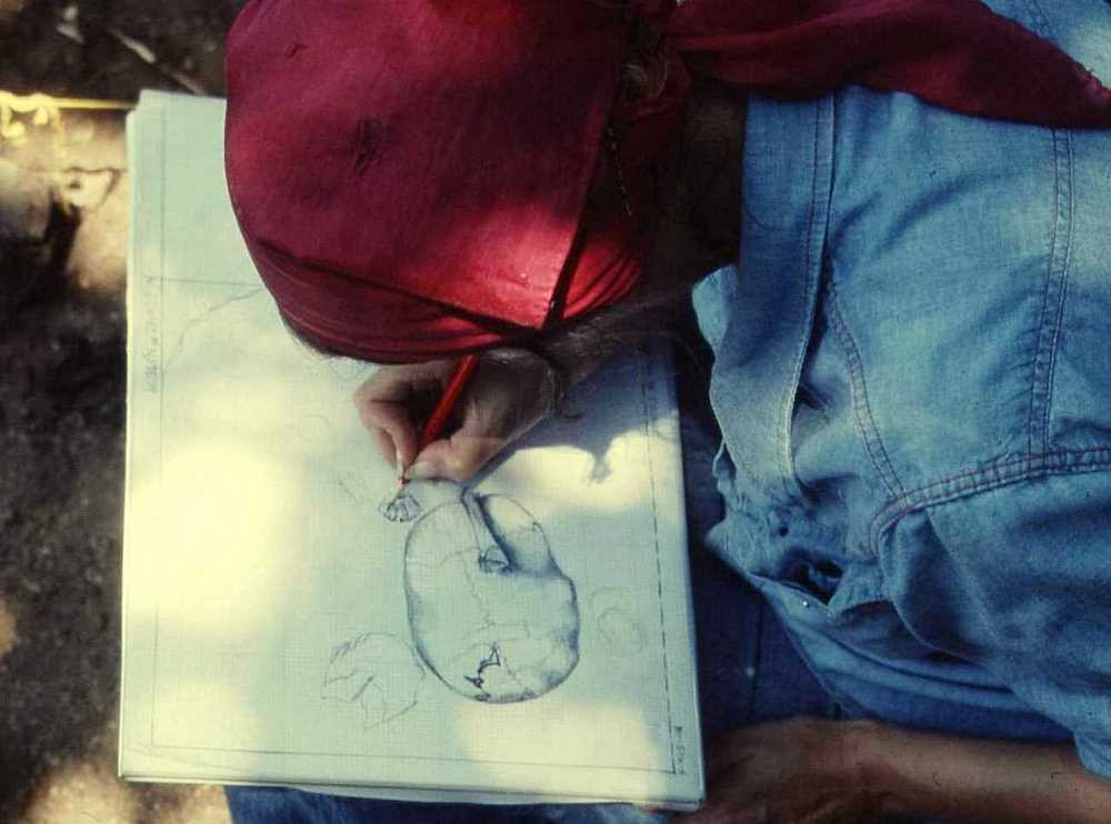 Image of a partially exposed burial in June, 1976.