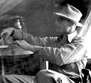 photo of Duffen examining artifacts 