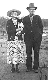 Mr. and Mrs. A.J. Hatchel, standing on temple mound on their farm, circa 1938.