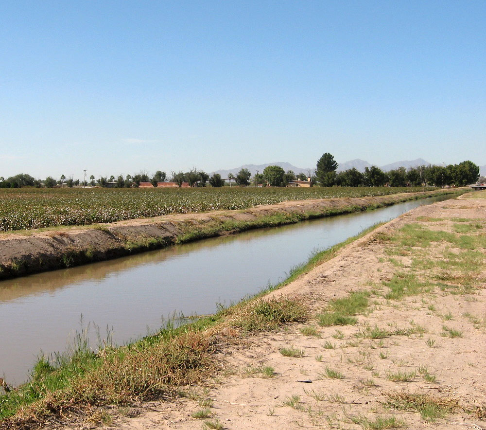 photograph of a plain with a trench filled with water running across it