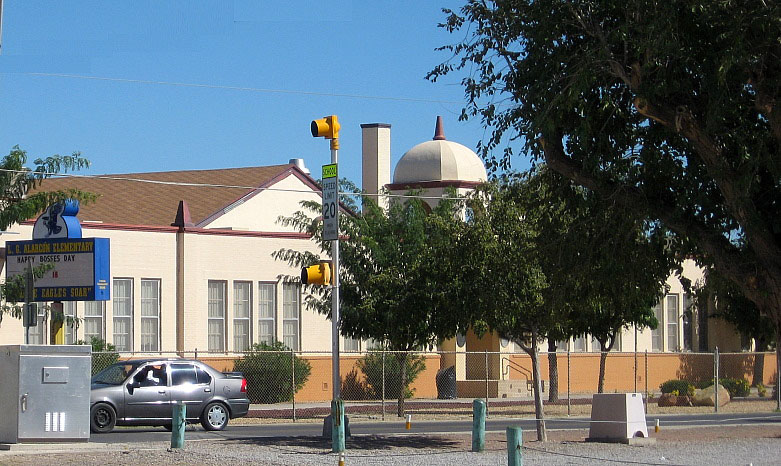photograph of a building with a tree in front of it