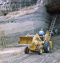 Mechanical and hand excavations in progress at Arenosa Shelter. Heavy equipment was needed because the deposits were over 40 feet deep. Photo from ANRA-NPS Archives at TARL.