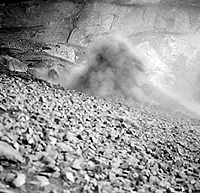 Excavation crew working in suffocating dust of Fate Bell Shelter in 1932. This problem has been faced by all excavators. The modern practice of sifting (screening) the soil has only made things worse. Dust churned up by the 1932 work and subsequent uncontrolled digging still adheres to the wall of the shelter and obscures the once-plain pictographs. Photo from ANRA-NPS Archives at TARL.