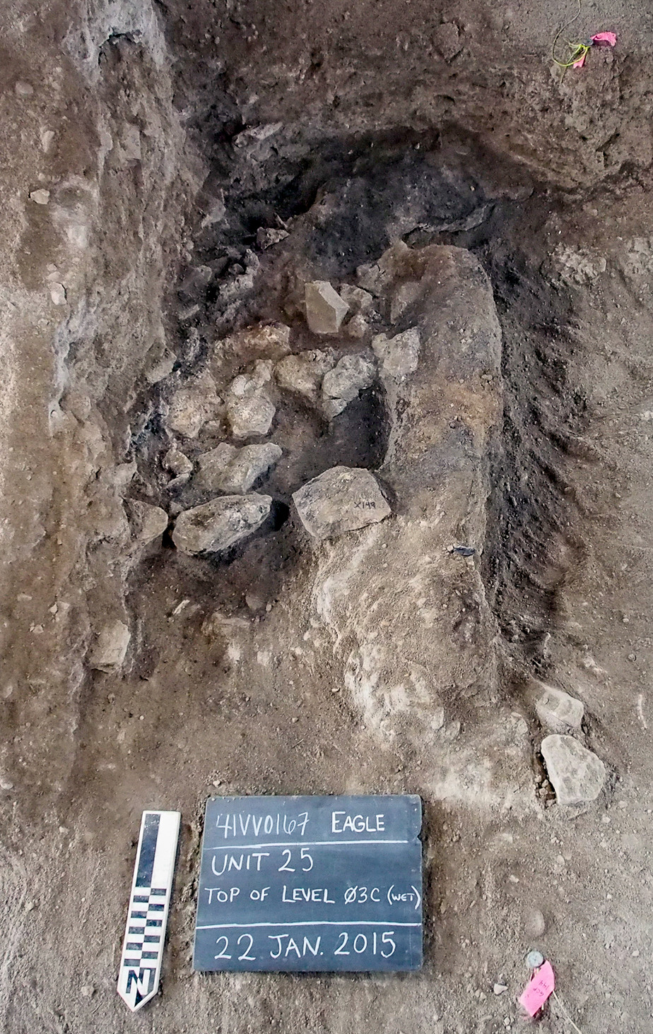 photo of fire-cracked rocks and carbon-stained sediment