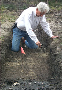 Mike Davis inspects an excavation unit at Fort St. Louis. Photo, courtesy of the Texas Historical Commission.