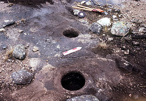 Photo of mortar holes carved into the bedrock of Squawteat Peak