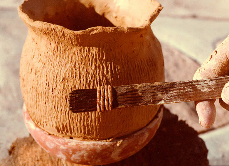 Photo of closeup view of a cordmarked pot in the process of construction