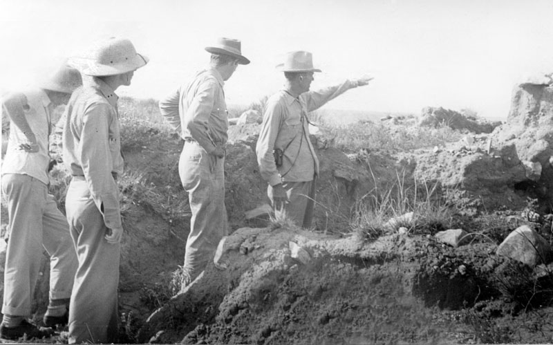 A visit to Bivins Ranch 1, Ruin 55, July 26, 1945, near what is today the Alibates Flint Quarry. Label reads: "Clarence Webb, Alex Krieger, Floyd Studer, and Clarence Webb, Jr., at ruin." Photo from TARL Archives.