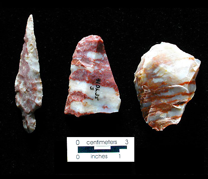 These reddish stones may have been chosen by ancient knappers for their unusual banding. The bifacial tool in the center has the look of beefsteak. Photo by Milton Bell.