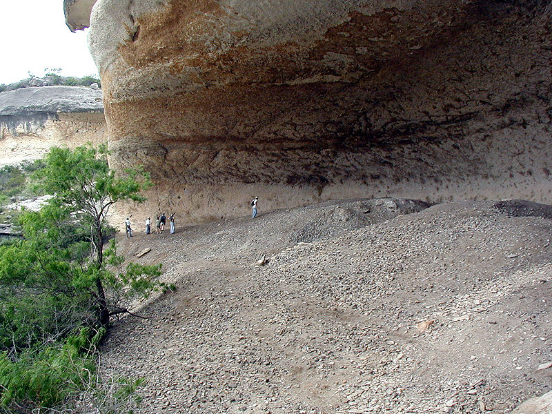 Eagle Cave is filled with massive trash deposits representing countless everyday activities in the lives of prehistoric hunter-gatherers. Called "midden" deposits by archeologists, these gray ashy layers are filled with spent cooking rocks, animal bone, plant remains, broken stone tools and all sorts of other artifacts and natural objects hauled into the shelter by its inhabitants.