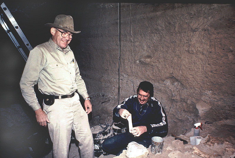 Dr. Ernest Lundelius (left) enjoys a moment while assisting in the collection of several mammoth bones from Bone Bed 1. Photo taken by Herb Eling., 1983-84.