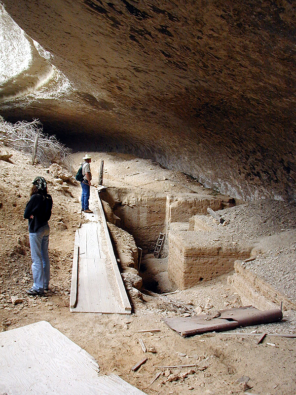 View from south end of the shelter to the central area where the main excavations have been carried out. The wooden walkway helps protect the still-open excavation holes from caving in.