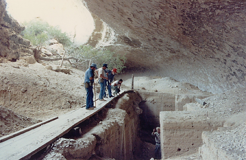 Main excavation area in center of Bonfire Shelter. Dave Dibble (in deep pit) explains an idea during his last visit to the site. Photo by Jack Skiles.