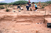 Crew chief Rob Vantil points out the progress in the excavation of Room 22, one of the deeper pithouses.