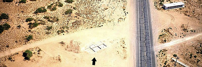 erial view of Firecracker Pueblo taken in 1980 after the first rooms of the pueblo were exposed. Across Highway 54 is an abandoned fireworks stand that gave the site its name.