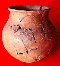 Red ware jar from small pueblo near Firecracker Pueblo. Locally made and has four suspension holes drilled below and evenly spaced around the rim. Similar modification is seen on pottery made in the Casas Grandes area.
