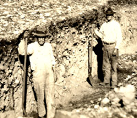 View of the 1930 excavations at Gault under the direction of James E. Pearce. Pearce focused on one of the most obvious archeological features at the site—a massive burned rock midden—the thick rocky layer extending from the surface to below the workmen's waists.