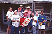 Members of the regional survey get their turn with the Explorer's Club flag.