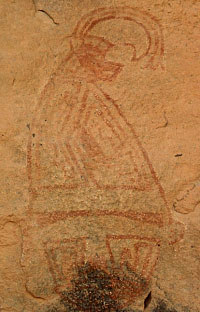 photo of a red mask topped by a conical cap