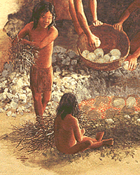bulbs and roots of plants being loaded into an earth oven