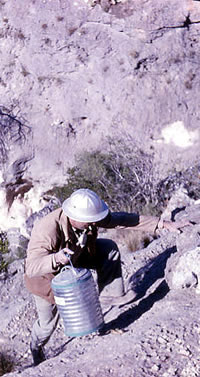 photo of man climbing with equipment
