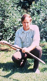 Archeologist Harry Shafer holds a wooden digging stick found in a dry cave. Digging sticks were probably the most important tool for Lower Pecos peoples because they could have served many different purposes in addition to digging.
