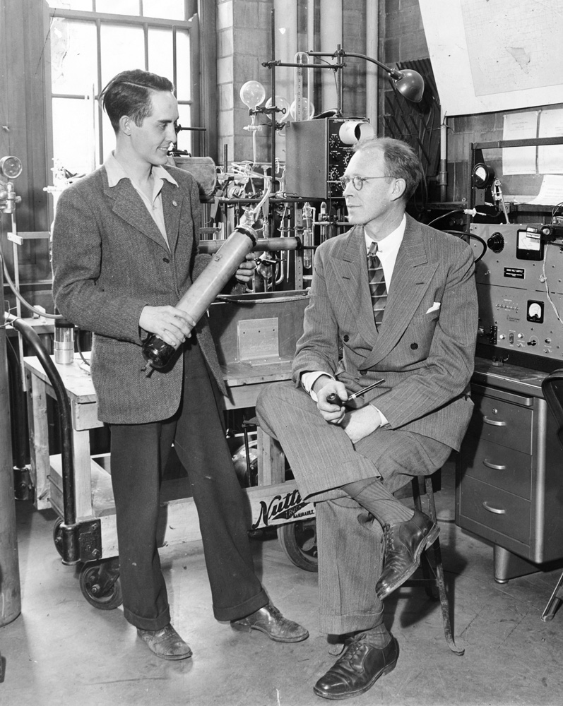 black and white photo of two men in laboratory