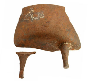 photo of rusty remnants are the remains of a Dutch oven, called a spider oven, found on the farm