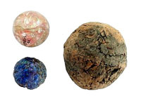photo of glass marbles and a rubber ball