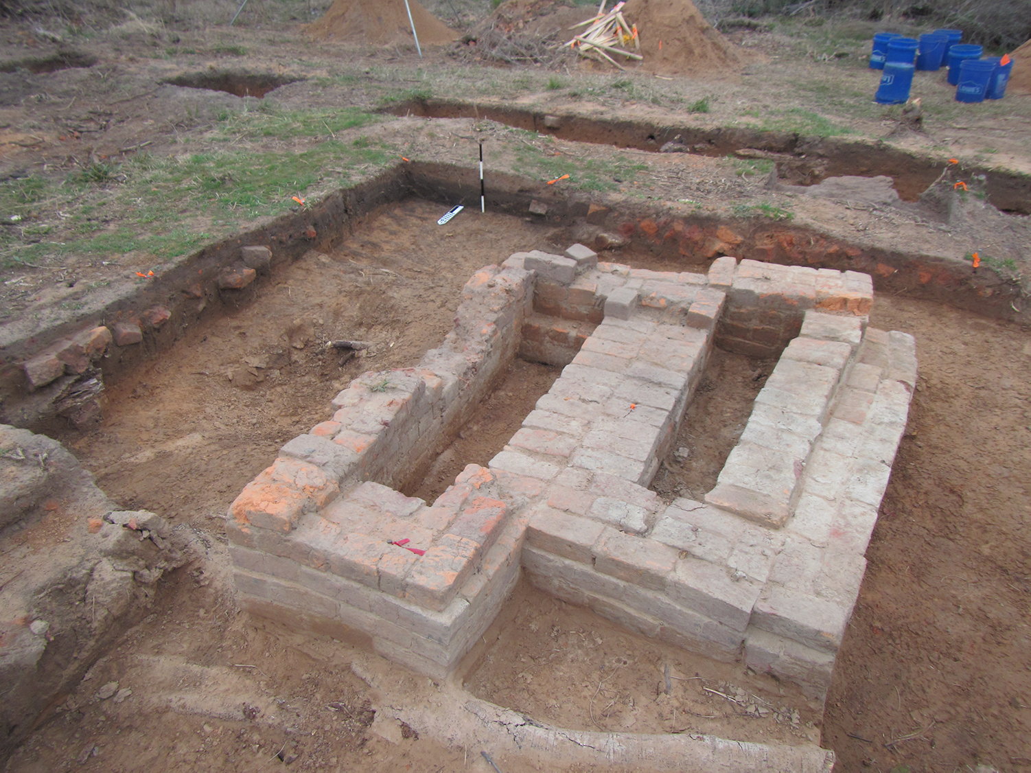 photo of excavation area mostly covered by patterns of bricks representing a chimney base.