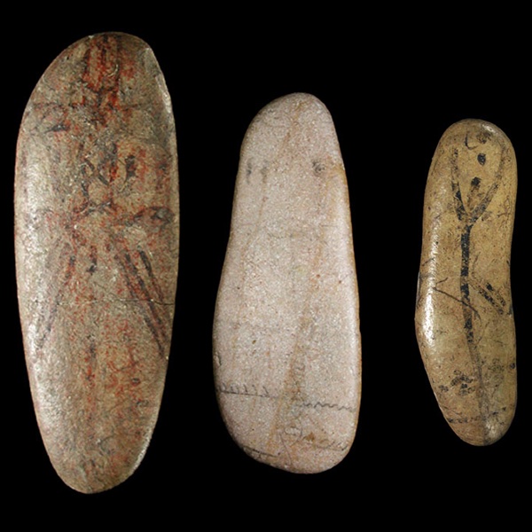 photograph of three painted pebbles